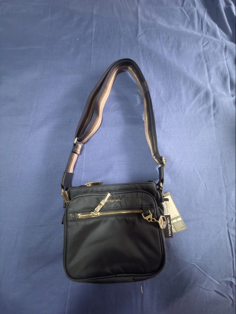 Hedgren Charm Magic Small Black Nylon Crossbody Bag (Category: Cross-body Bags) located in Pasig City. Submitted by sellers_block (Listing ID 1462096252, Image 1). Description: - Brand: Hedgren - Type: Crossbody Bag - Material: Black Nylon - Model: Charm Magic Small - Hardware: Gold-tone - Strap: Adjustable, striped - Condition: Smooth zippers, great for everyday use - original price is 4,999 Buyer will shoulder shipping.