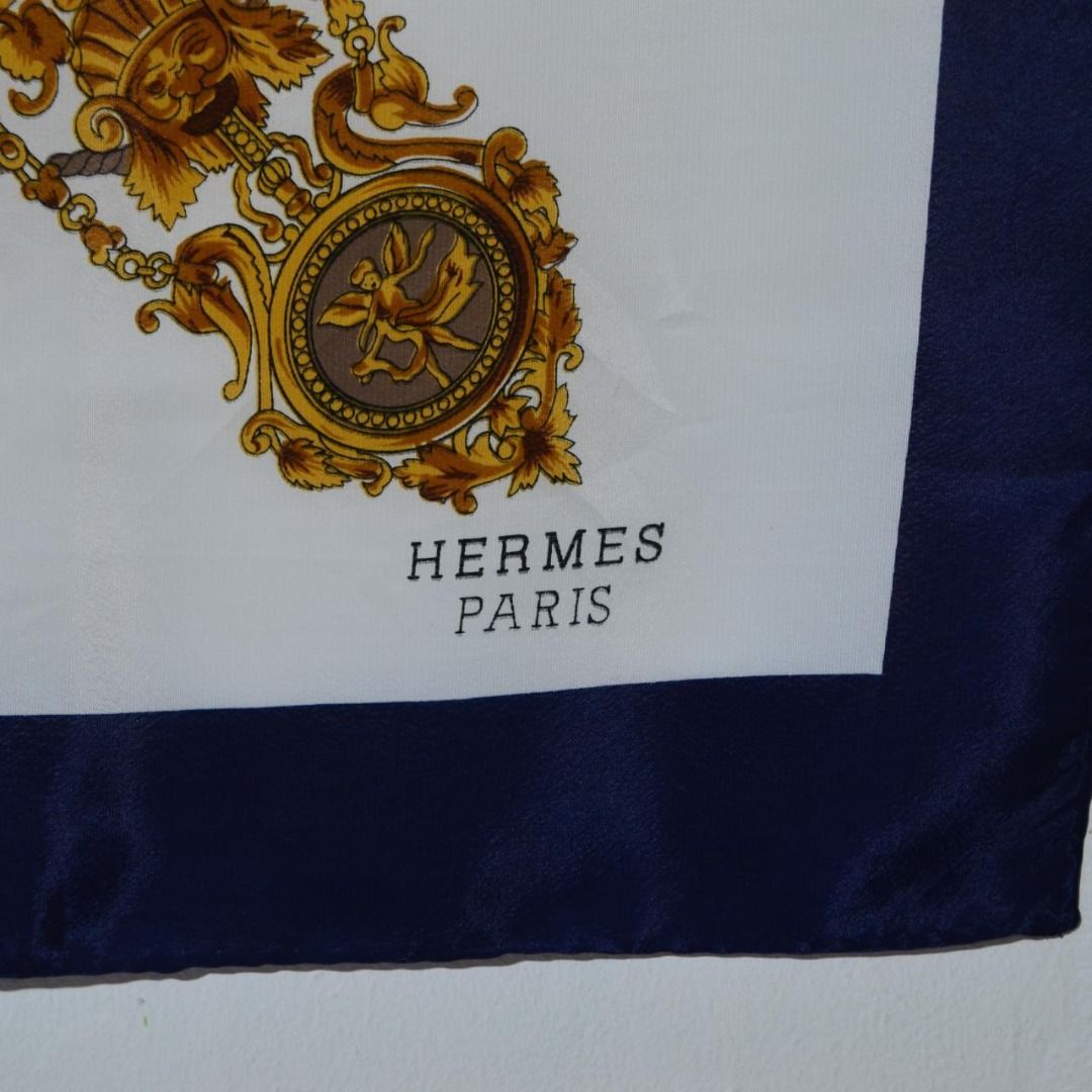 Hermes Paris 100% Silk Scarf Preloved (Category: Scarves) located in Polomolok. Submitted by lastthrift (Listing ID 1462201684, Image 2). Description: - Authentic Hermes Paris scarf - 100% Silk, Made in France - Classic gold and navy design with intricate details - Size: Approx. 90cm x 90cm - Timeless luxury accessory for any wardrobe - 34x34".