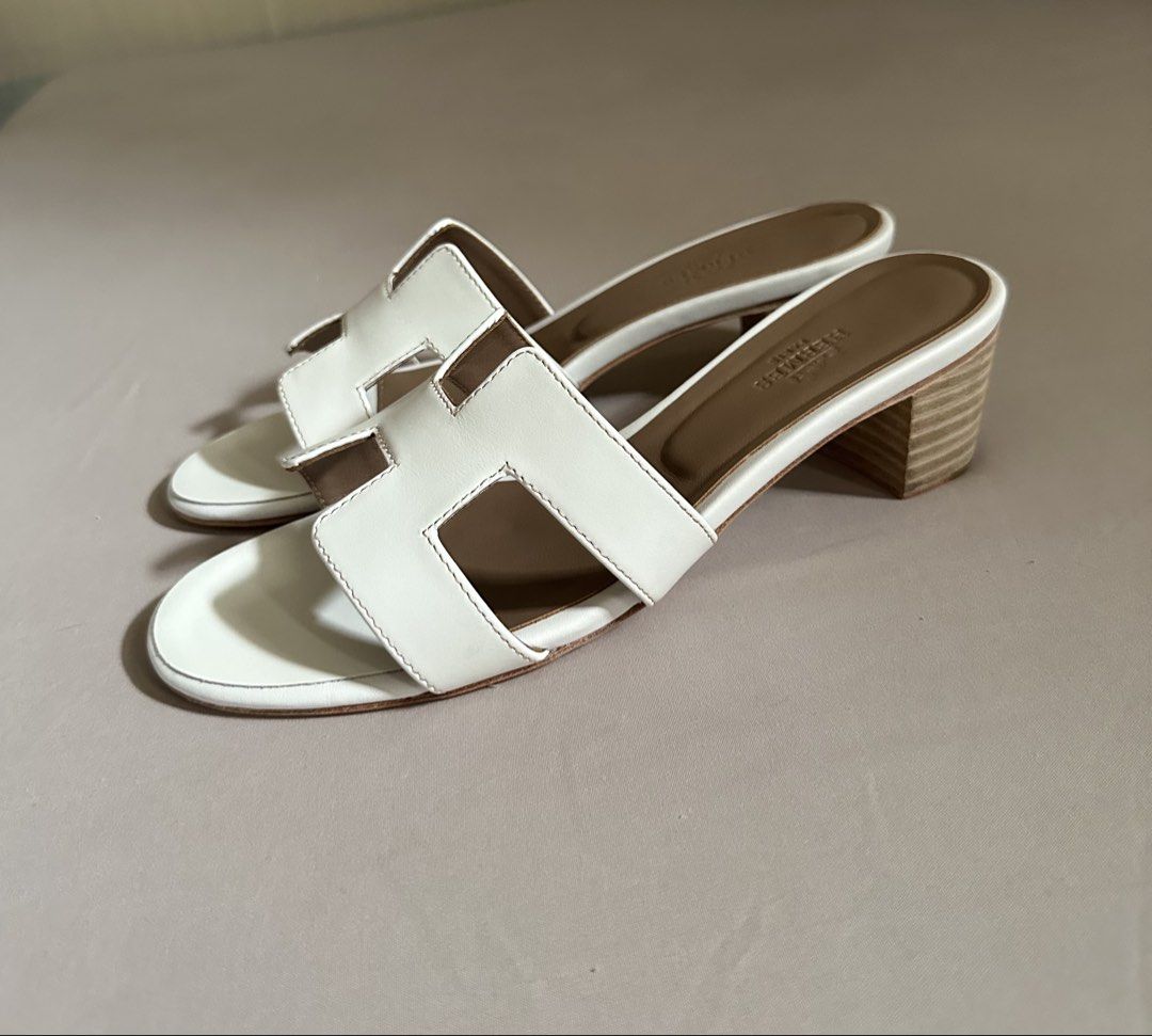 Hermes sandals (Category: Flats & Sandals) located in Legazpi City. Submitted by gettinmycloset01 (Listing ID 1462121752, Image 2). Description: - Authentic white leather Hermes oasis sandals - Features the iconic 'H' design - Comfortable block heel for all-day wear - Classic and chic style - Perfect for dressing up or down - A versatile addition to your wardrobe.