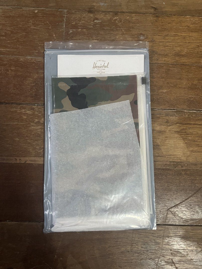 HERSCHEL Camo Plastic Sleeve for Documents Organizer (Category: Stationery & School Supplies) located in Manila. Submitted by carmiscloset (Listing ID 1462121631, Image 2). Description: - Brand: Herschel - Item: Plastic Sleeve for Documents Organizer - Design: Camouflage print - Material: Durable plastic - Function: Organizes documents, papers, and small notebooks - Style: Trendy and practical.
