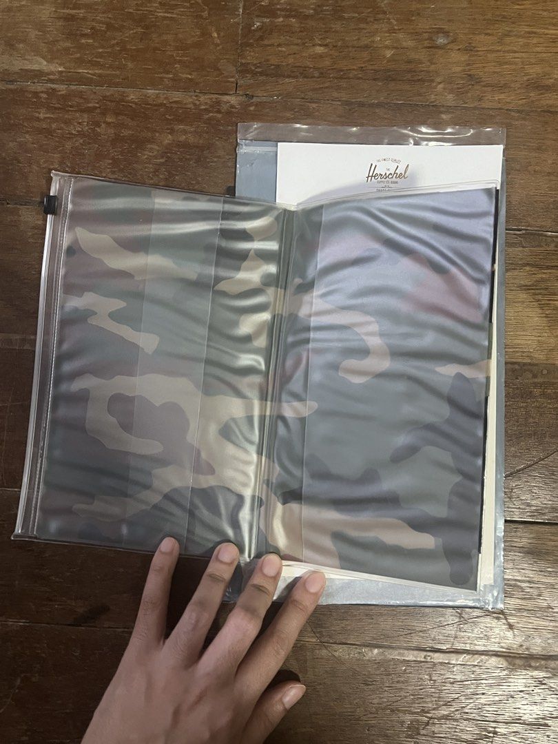 HERSCHEL Camo Plastic Sleeve for Documents Organizer (Category: Stationery & School Supplies) located in Manila. Submitted by carmiscloset (Listing ID 1462121631, Image 3). Description: - Brand: Herschel - Item: Plastic Sleeve for Documents Organizer - Design: Camouflage print - Material: Durable plastic - Function: Organizes documents, papers, and small notebooks - Style: Trendy and practical.