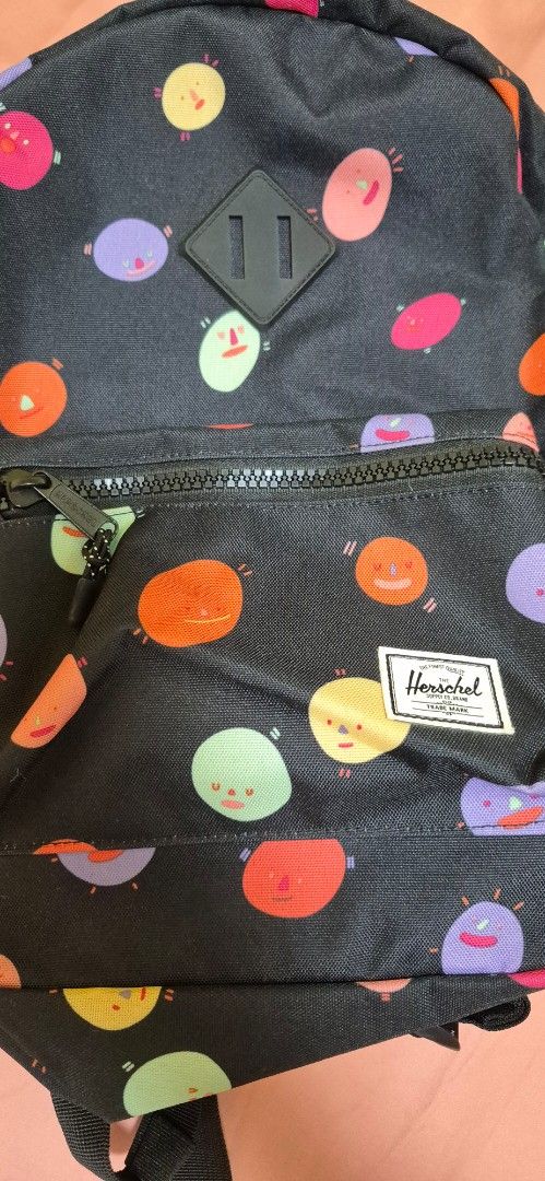 Herschel Supply Co. Backpack - Funky Polka Dot Print (Category: Backpacks) located in Pasig City. Submitted by decluttermyclosetph (Listing ID 1462130973, Image 2). Description: - Fun polka dot print (black base with pink, orange, purple, green dots) - Front zip pocket for easy access - Spacious main compartment with internal pockets - Adjustable straps for comfortable carrying - Ideal for school, travel, or everyday adventures.