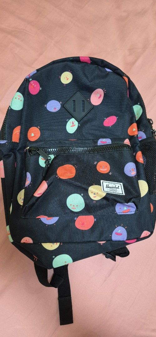 Herschel Supply Co. Backpack - Funky Polka Dot Print (Category: Backpacks) located in Pasig City. Submitted by decluttermyclosetph (Listing ID 1462130973, Image 1). Description: - Fun polka dot print (black base with pink, orange, purple, green dots) - Front zip pocket for easy access - Spacious main compartment with internal pockets - Adjustable straps for comfortable carrying - Ideal for school, travel, or everyday adventures.