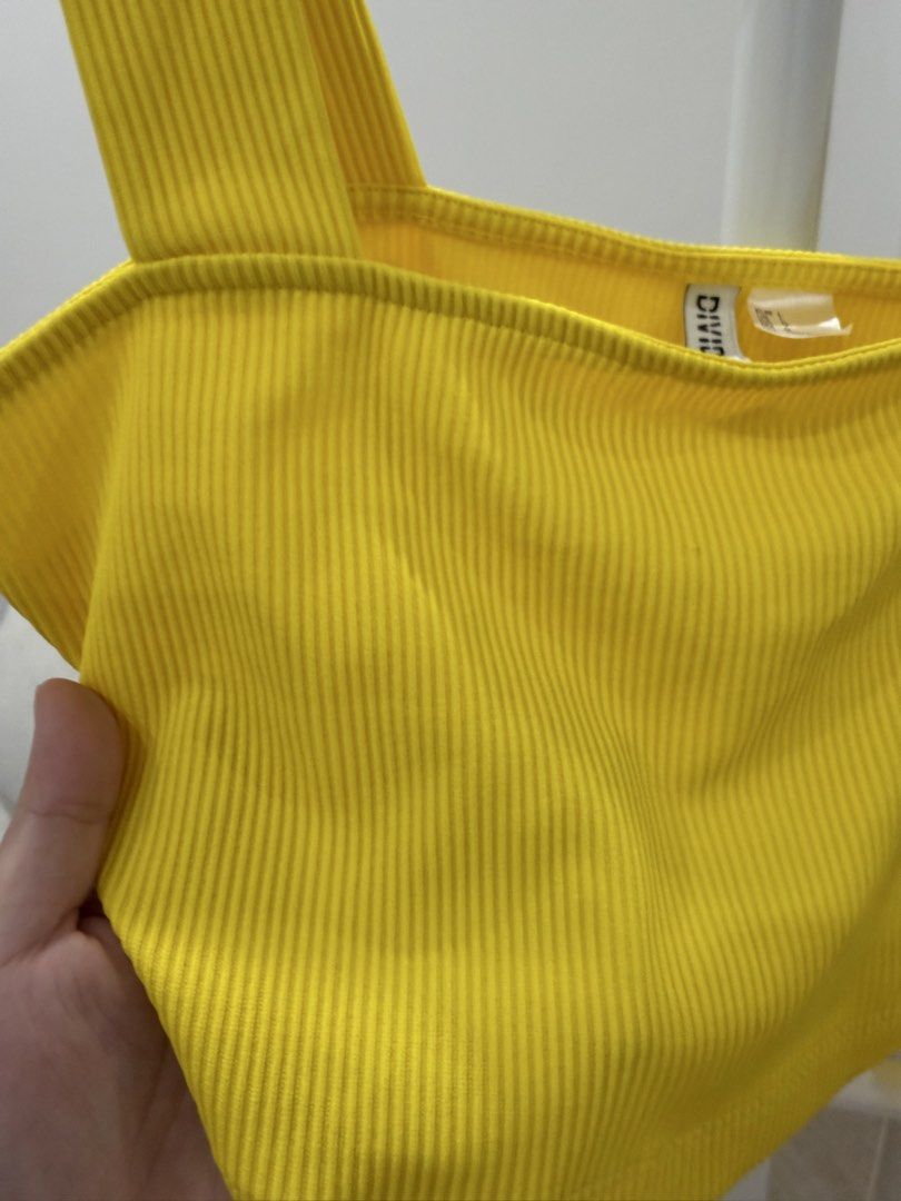 H&M Divided Yellow Ribbed Crop Top (Category: Shirts) located in Talisay. Submitted by itslucym (Listing ID 1462156759, Image 3). Description: - Yellow ribbed crop top - Brand: H&M Divided - Size: L - Material: Comfortable and stretchy - Versatile: Great for casual wear, layering, or pairing with jeans/skirts.