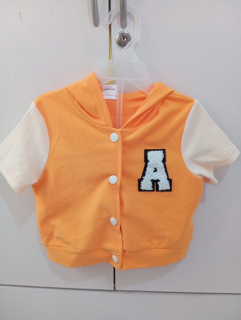 Hoodie terno and Shorts Set (Category: Babies & Kids Fashion) located in Manila. Submitted by brion123 (Listing ID 1462050581, Image 1). Description: - Adorable orange hoodie top with cream sleeves - Features a cute letter 'A' patch on the top - Matching orange shorts with stylish cream side stripes - Shorts have a comfortable elastic waistband - Ideal for casual outings and active playtime - Fun and sporty outfit for kids.