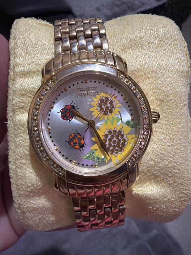 Invicta Rose Gold Sunflower Ladybug Watch (Category: Women's Watches) located in Las Pinas. Submitted by ces0427 (Listing ID 1462064660, Image 1). Description: - Adorable Invicta watch featuring a charming sunflower and ladybug design. - Stylish rose gold tone metal band. - Shows some signs of wear on the band, as pictured. - Includes the original Invicta box. - Perfect for adding a playful touch to any outfit..