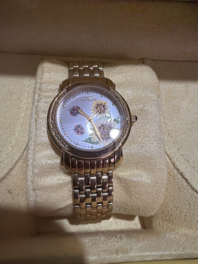Invicta Rose Gold Sunflower Ladybug Watch (Category: Women's Watches) located in Las Pinas. Submitted by ces0427 (Listing ID 1462064660, Image 2). Description: - Adorable Invicta watch featuring a charming sunflower and ladybug design. - Stylish rose gold tone metal band. - Shows some signs of wear on the band, as pictured. - Includes the original Invicta box. - Perfect for adding a playful touch to any outfit..
