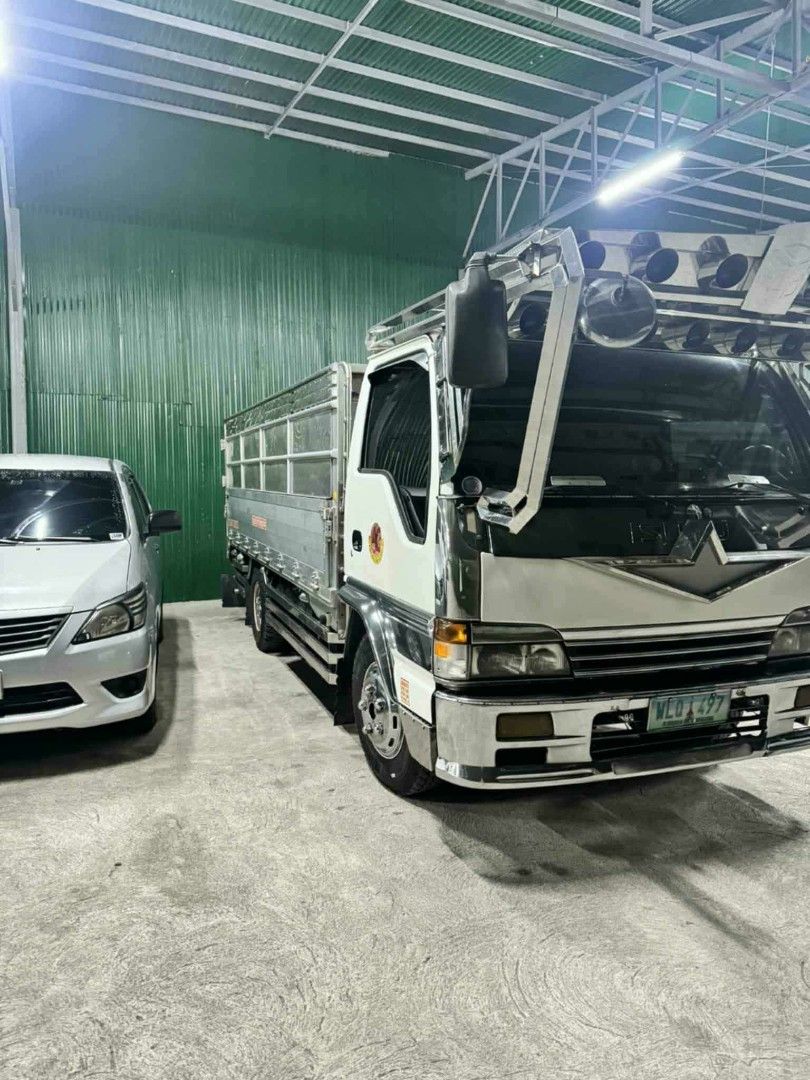 Isuzu Elf Minibus (Category: Used Cars) located in Binan City. Submitted by ejmzxc (Listing ID 1462197625, Image 3). Description: ISUZU ELF 1998 DROP SIDE STAINLESS 4HG1 ENGINE (6 GEARS) GOOD RUNNING CONDITION COMPLETE LEGAL PAPERS FIRST OWNER READY TO TRANSFER REGISTERED UNTIL 2026 AIRCON WORKING DOUBLE TIRE 750 X 16 (95%) 14 FT" DROP SIDE STAINLESS D7 BRAKE ALL LIGHTS WORKING LOCATION: STA ANA PAMPANGA PM SA SURE BUYER 800,000 NEGO.