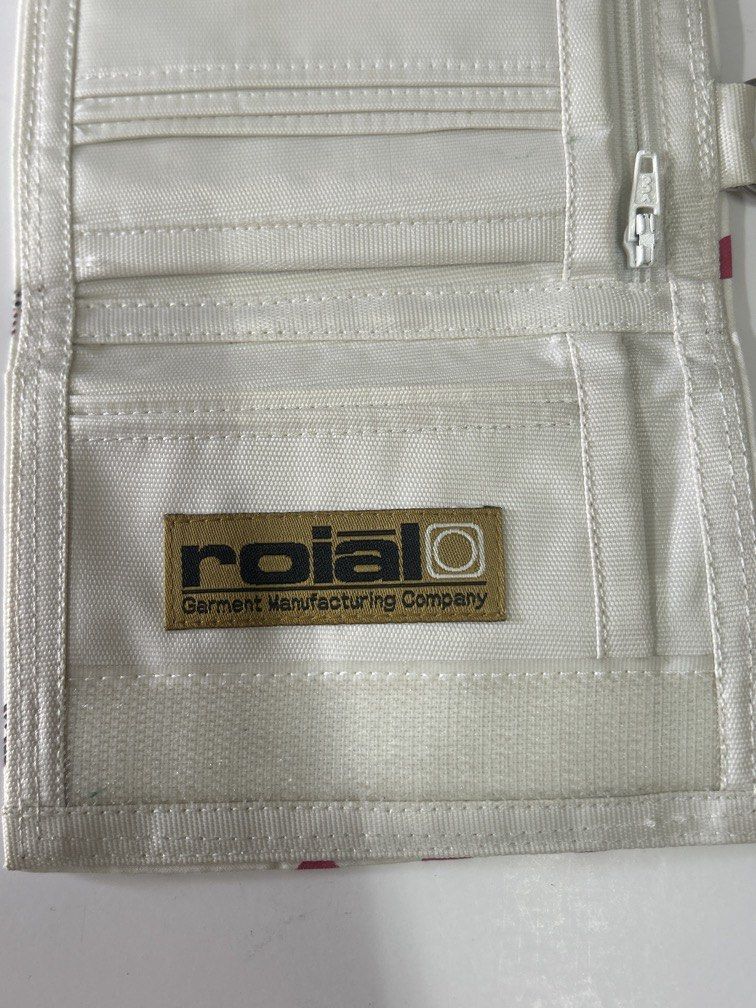 Japan brand wallet roial (Category: Wallets & Card Holders) located in Bulacan. Submitted by ourdailybreads (Listing ID 1462048498, Image 3). Description: The image shows an open white fabric trifold wallet with a woven brown label that reads “roial Garment Manufacturing Company”..
