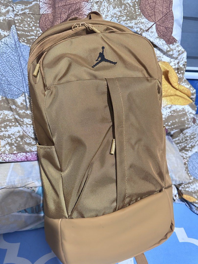 Jordan Jumpman Gold Backpack (Category: Backpacks) located in Paranaque City. Submitted by cjc0622 (Listing ID 1462142589, Image 3). Description: - Stylish gold Jordan backpack - Iconic Jumpman logo on the front - Convenient side pockets for essentials - Comfortable padded shoulder straps - Separate compartment at the bottom for extra storage - Ideal for school, gym, or everyday use - Bought in California .
