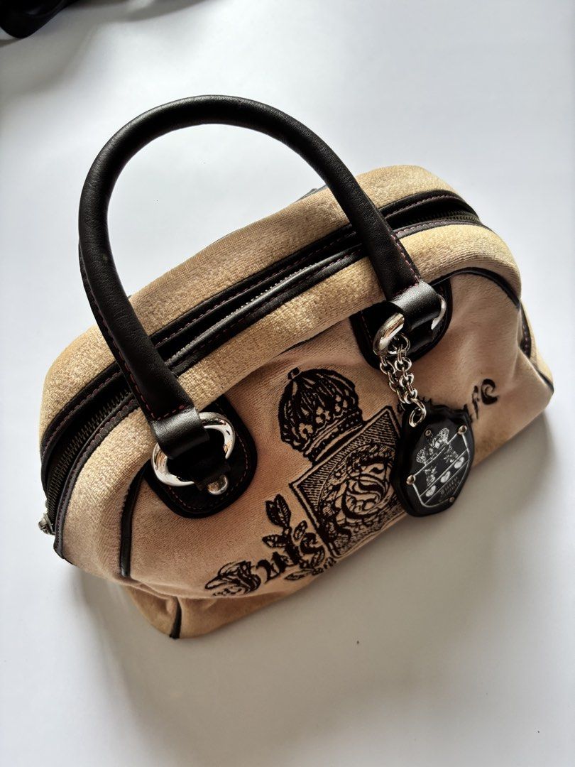 Juicy Couture Velour Bowler Bag (Category: Luxury Bags & Wallets) located in Manila. Submitted by anik.anik_ph (Listing ID 1462089316, Image 3). Description: - Adorable velour handbag from Juicy Couture - Features the iconic crest logo embroidery - Genuine leather handles and trim for a touch of luxury - Comes with a charming heart-shaped accessory - Ideal for your everyday adventures Juicy Couture Velour Bowler Bag W 11 L 9 vintage Juicy Couture