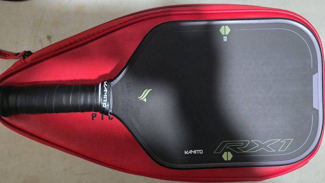 KAMITO RX1 Pickleball Paddle with Red Case (Category: Racket and Ball Sports) located in Quezon City. Submitted by andrewarr (Listing ID 1462261368, Image 2). Description: - KAMITO RX1 pickleball paddle - Stylish black design with green accents - Open NFC - Comes with a red protective case - Perfect for your next pickleball game - Ready for a new owner.