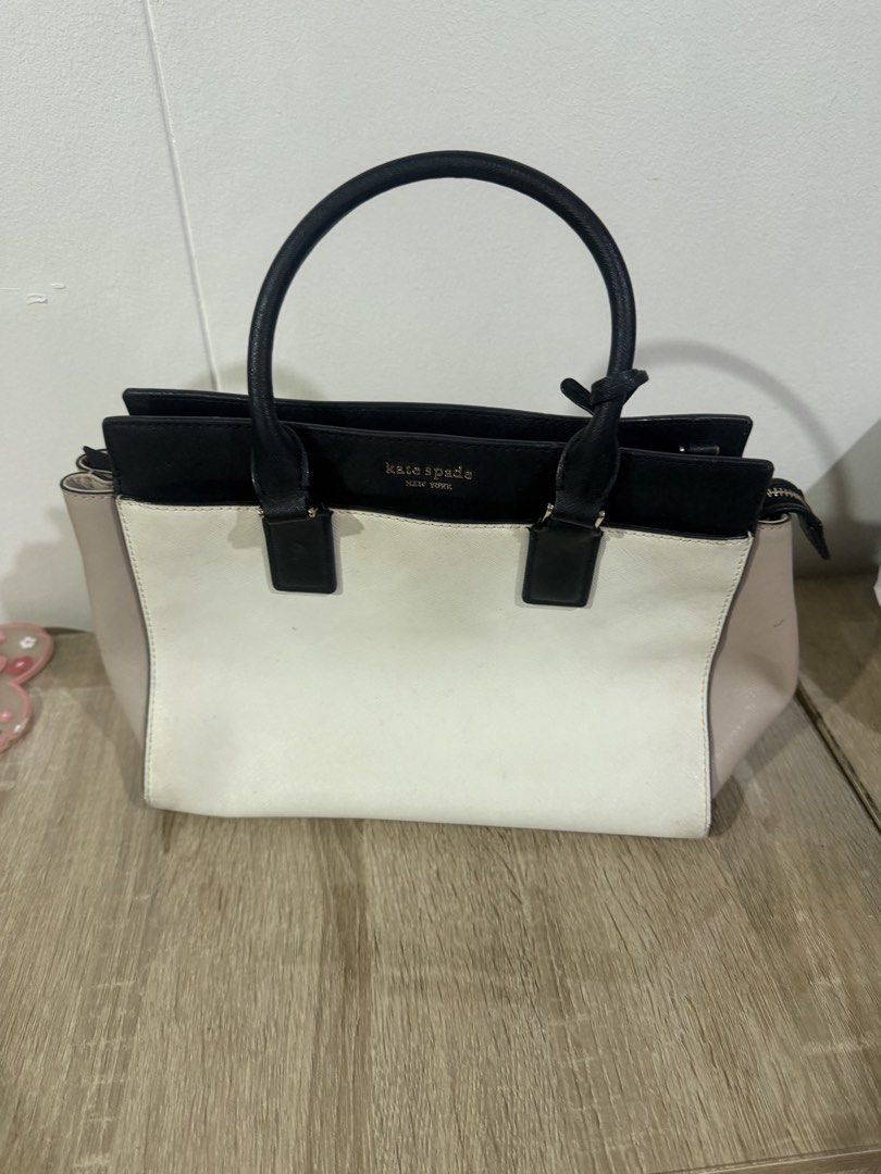 Kate Spade Colorblock Leather Tote Bag (Category: Tote Bags) located in Paranaque City. Submitted by kaina1849240 (Listing ID 1462216567, Image 1). Description: - Authentic Kate Spade tote bag - Stylish colorblock design: black, white, and beige panels - Genuine leather material - Comfortable top handles - Secure zip closure - Protective studs on the bottom - Spacious interior, perfect for everyday essentials - Note: Minor marks on the white sect