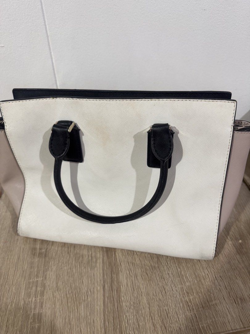 Kate Spade Colorblock Leather Tote Bag (Category: Tote Bags) located in Paranaque City. Submitted by kaina1849240 (Listing ID 1462216567, Image 3). Description: - Authentic Kate Spade tote bag - Stylish colorblock design: black, white, and beige panels - Genuine leather material - Comfortable top handles - Secure zip closure - Protective studs on the bottom - Spacious interior, perfect for everyday essentials - Note: Minor marks on the white sect