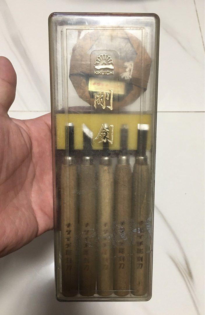 Kikuichi Wood Carving Chisel Set (Category: Craft Supplies & Tools) located in Pasay City. Submitted by gilbertso62551 (Listing ID 1462145380, Image 1). Description: - Set of 5 Kikuichi wood carving chisels - Features wooden handles and durable metal blades - Includes a variety of blade shapes for diverse carving needs - Ideal for detailed wood carving projects - Made in Taiwan - Comes in a clear plastic case with yellow foam insert for storage -