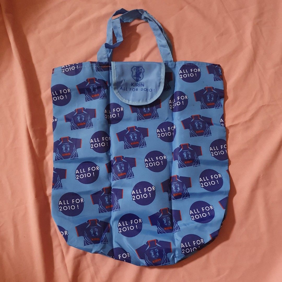 Kirin JFA All For 2010 Blue Reusable Shopping Bag bundle (Category: Tote Bags) located in Paranaque City. Submitted by cobien (Listing ID 1462188881, Image 1). Description: - Set of 2 blue reusable shopping bags - Features a fun 'Kirin All For 2010!' and football jersey pattern - Ideal for groceries, shopping, or everyday use - Folds up neatly for easy storage - Excellent value for both bags.