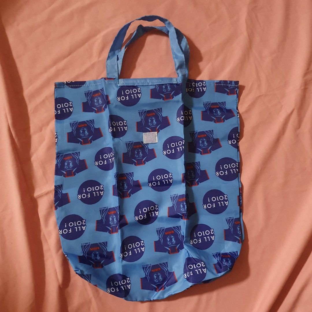 Kirin JFA All For 2010 Blue Reusable Shopping Bag bundle (Category: Tote Bags) located in Paranaque City. Submitted by cobien (Listing ID 1462188881, Image 2). Description: - Set of 2 blue reusable shopping bags - Features a fun 'Kirin All For 2010!' and football jersey pattern - Ideal for groceries, shopping, or everyday use - Folds up neatly for easy storage - Excellent value for both bags.