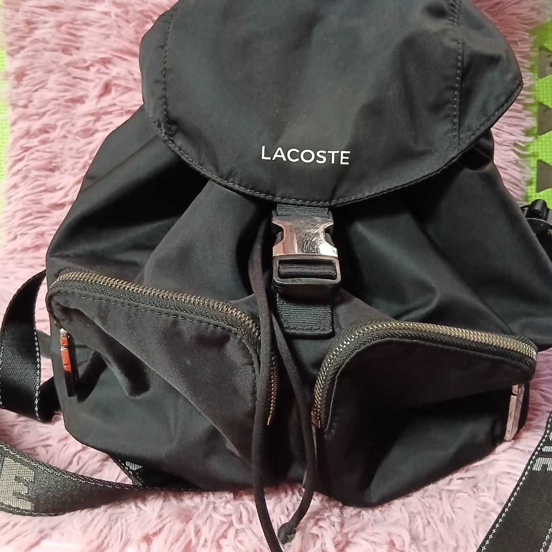 Lacoste Black Nylon Backpack (Category: Backpacks) located in Caloocan City. Submitted by rame_finds (Listing ID 1462226966, Image 1). Description: - Authentic Black Lacoste Backpack - Secure buckle closure on flap - Multiple zippered pockets for organization - Adjustable straps for comfortable wear - Ample interior space - Ideal for everyday use, school, or travel.