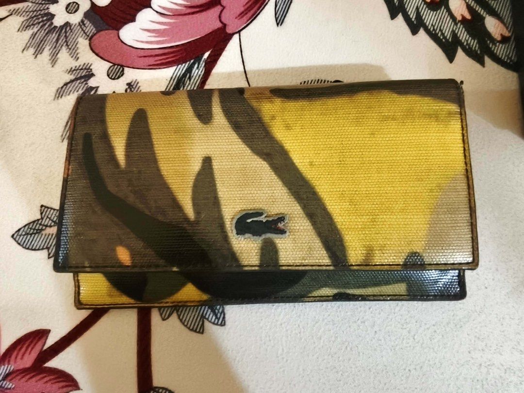 Lacoste Camouflage Wallet (Category: Wallets & Card holders) located in Taguig. Submitted by vanityandstuffbyelena (Listing ID 1462096367, Image 1). Description: ALL AUTHENTIC -Cool camouflage design from Lacoste - Multiple card slots and cash compartment - Shiny, textured exterior finish - Secure snap closure - Shows some signs of wear, but still functional.