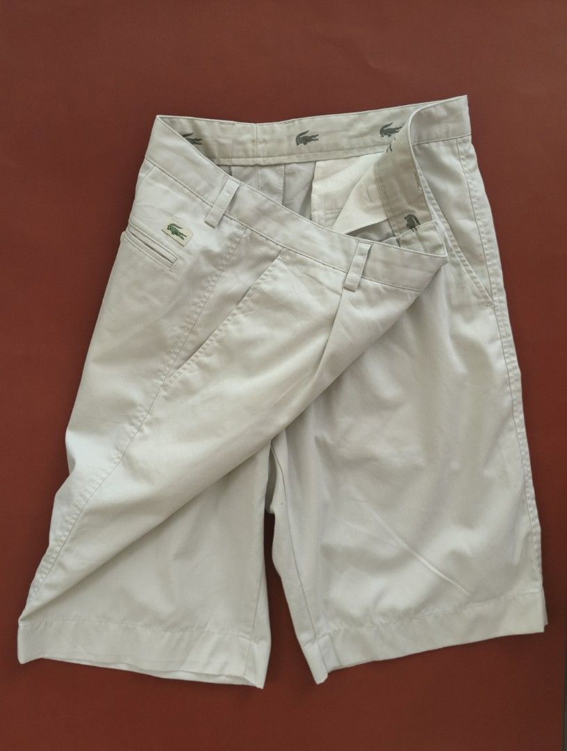 LACOSTE Men's Chino Shorts Med (Category: Shorts) located in Cebu City. Submitted by little_mush.room (Listing ID 1462090385, Image 1). Description: - preloved Classic beige chino shorts from Lacoste - Iconic crocodile logo on front pocket and back - Pleated front design - Button and zip closure - Size: medium measurements posted.