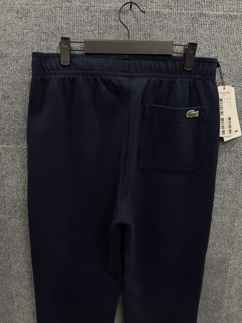 Lacoste Navy Blue Jogger Sweatpants (Category: Activewear) located in Marikina City. Submitted by grindmanila (Listing ID 1462120874, Image 2). Description: UNISEX 📌 LARGE FITS✔️ SIZE: 36 ON TAG 30 - 35 WAISTLINE 38 LENGTH BRANDNEW✅.