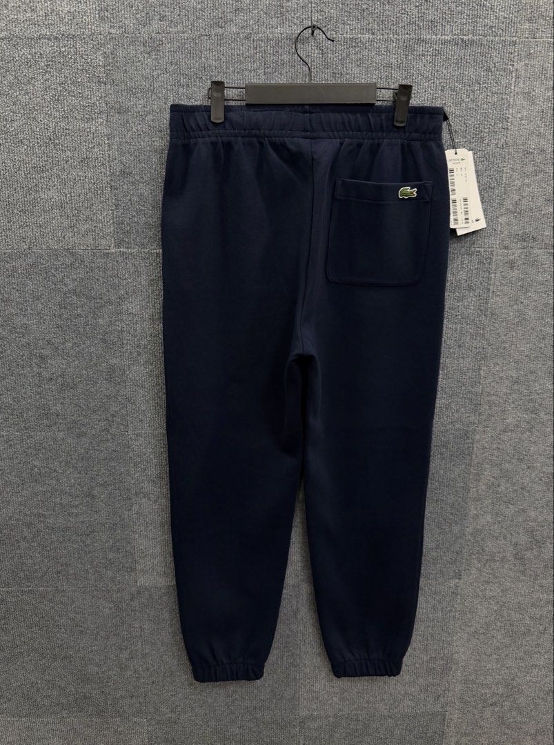 Lacoste Navy Blue Jogger Sweatpants (Category: Activewear) located in Marikina City. Submitted by grindmanila (Listing ID 1462120874, Image 1). Description: UNISEX 📌 LARGE FITS✔️ SIZE: 36 ON TAG 30 - 35 WAISTLINE 38 LENGTH BRANDNEW✅.