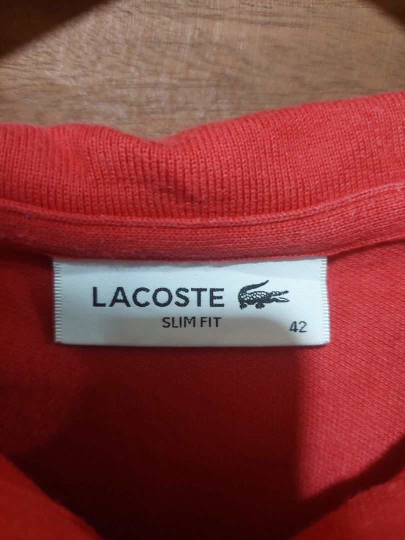 Lacoste Red Polo Shirt (Category: Others Tops) located in Bagac. Submitted by sweet_repeats2021 (Listing ID 1462175702, Image 2). Description: - Red Lacoste Polo Shirt - Size: M - Fit: Slim fit - Features: Classic crocodile logo on chest, button-up neckline - Style: Perfect for casual or smart casual occasions.