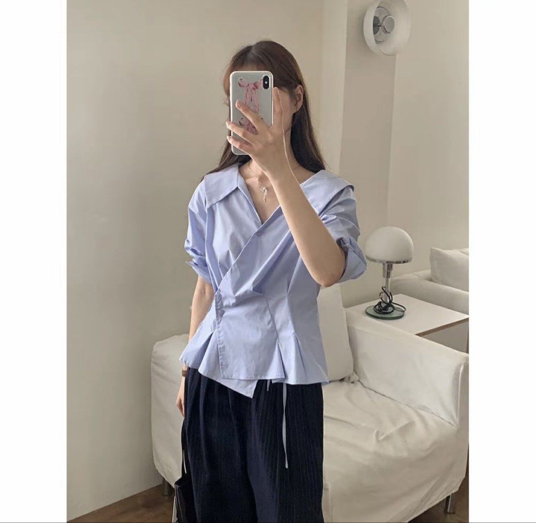 Light Blue Asymmetrical Peplum Blouse with Collar (Category: Blouses) located in Baguio. Submitted by declutterbycys (Listing ID 1462116784, Image 2). Description: - Light blue blouse - Unique asymmetrical peplum hem - Wide collar - Wrap-style front with button closure - Cuffed sleeves (rollable) - Can be tucked in or worn out - Versatile for dressing up or down.
