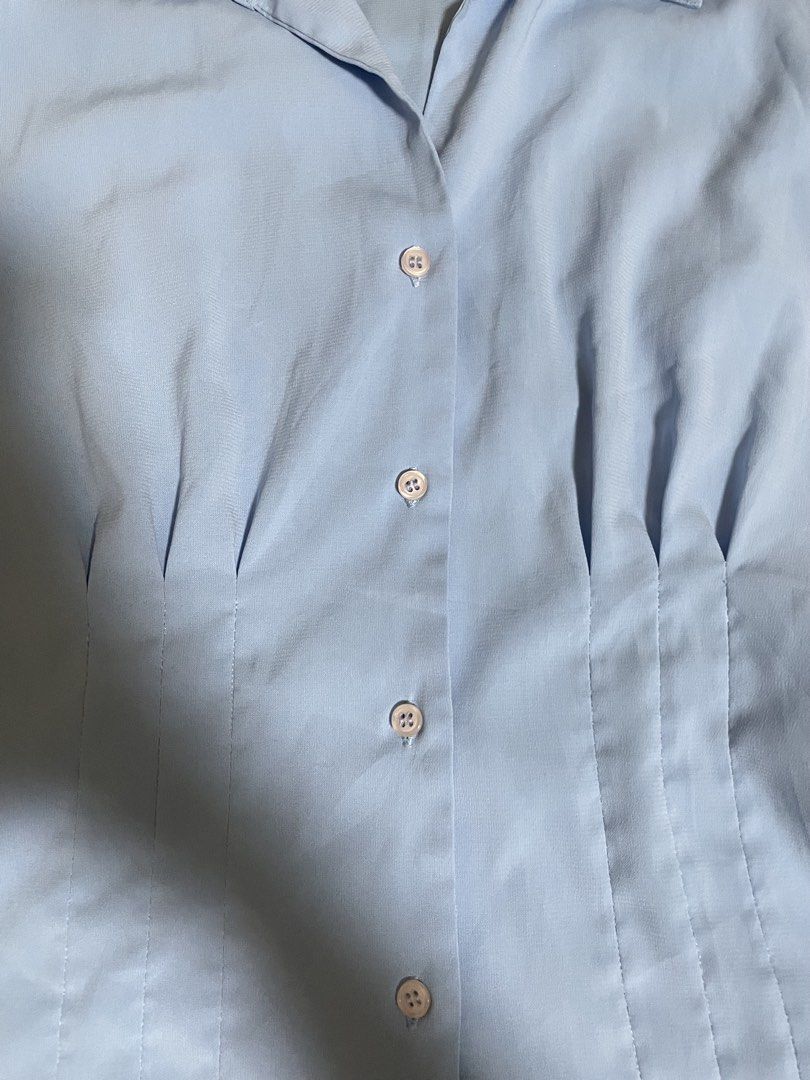 Light Blue Short Sleeve Collared Button Up Blouse Formal Top Preloved (Category: Blouses) located in San Juan, La Union. Submitted by nicaaas (Listing ID 1462126822, Image 2). Description: no issues laid flat measurements: waist: 17.5 inches length: 20.5 inches arm: 6.5 inches - Light blue short sleeve blouse - Collared neckline with button-up front - Fitted waist with dart details - Simple and classic design - Versatile for work or casual wear -