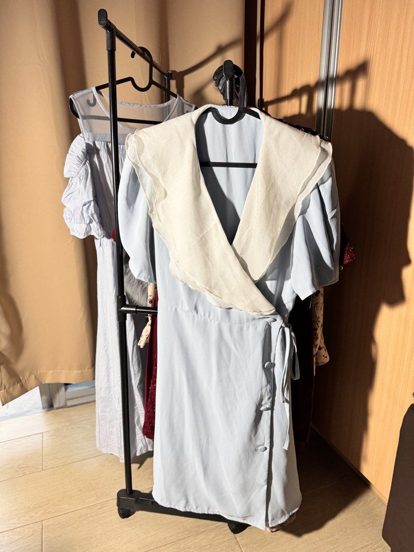 Light Blue Wrap Dress with White Ruffle Collar (Category: Dresses) located in Manila. Submitted by maichandise (Listing ID 1462156947, Image 2). Description: - White ruffle collar - Tie waist closure - Button detail on the side - Versatile for casual outings or office wear - Easy to style Item is preloved 🥰.