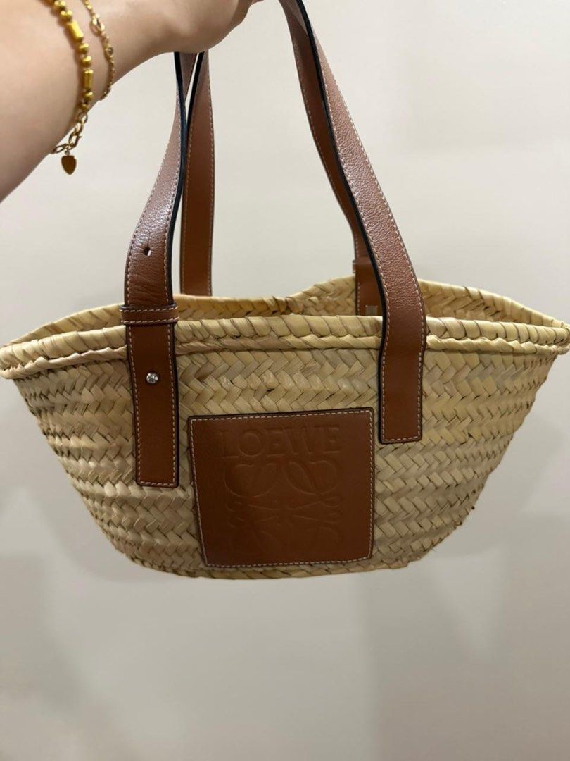 Loewe Basket Bag with Leather Handles (Small) (Category: Luxury Bags & Wallets) located in Manila. Submitted by poppymart0525 (Listing ID 1462166831, Image 2). Description: - Authentic Loewe straw basket bag - Features brown leather handles and trim - Iconic Loewe anagram logo embossed on leather patch - Perfect size for everyday essentials - Woven straw material - Great for summer outings.