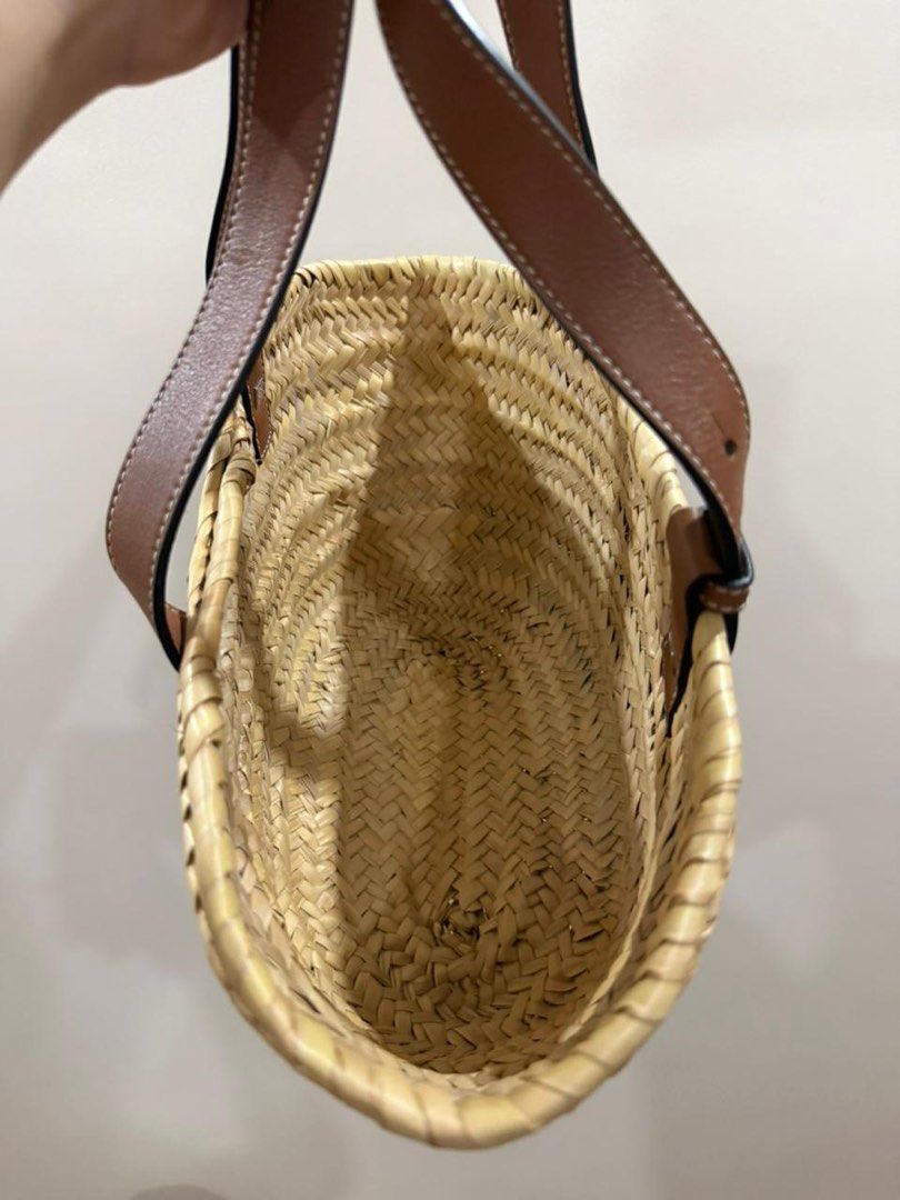 Loewe Basket Bag with Leather Handles (Small) (Category: Luxury Bags & Wallets) located in Manila. Submitted by poppymart0525 (Listing ID 1462166831, Image 3). Description: - Authentic Loewe straw basket bag - Features brown leather handles and trim - Iconic Loewe anagram logo embossed on leather patch - Perfect size for everyday essentials - Woven straw material - Great for summer outings.