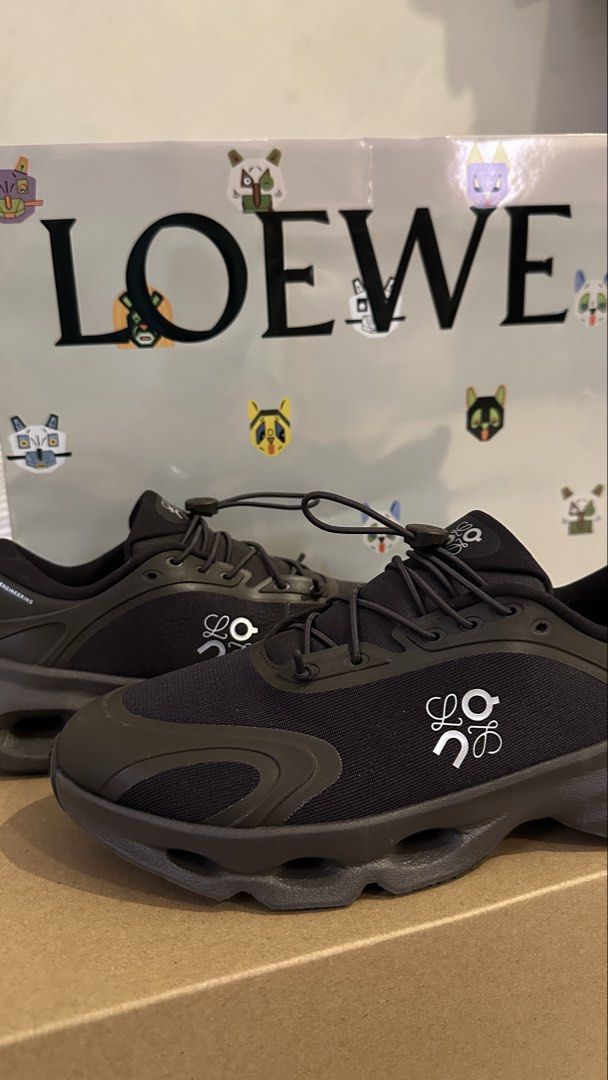 Loewe Cloudsolo Dark Brown/Black (Category: Sneakers) located in Dagupan City. Submitted by gjems_ (Listing ID 1462201862, Image 1). Description: - Authentic Loewe black sneakers - Features iconic white Loewe anagram logo on the side - Secure toggle lace-up closure - Stylish chunky sole design - Ideal for everyday wear and light activities - Comes with original Loewe dust bag.