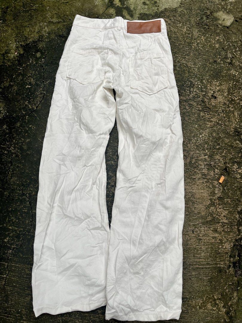 LOEWE White Cotton Wide Leg Pants (Category: Other Bottoms) located in Manila. Submitted by shanaaa.collects (Listing ID 1462123988, Image 2). Description: - Brand: LOEWE - Color: White - Fit: Wide leg - Material: 100% Cotton - Features: Iconic LOEWE anagram embroidery on front legs, button and zip closure, leather patch on back - Size: M waist-28/30 lenght-42.