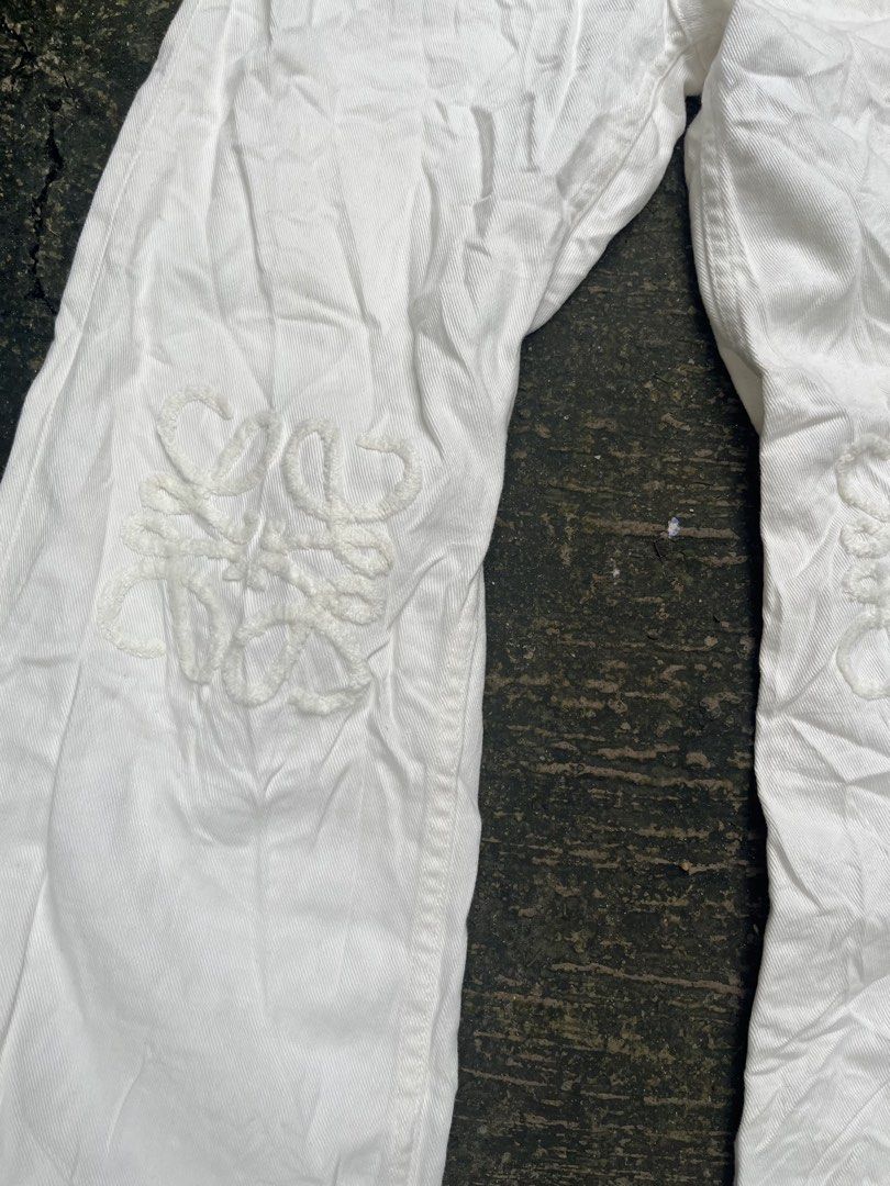 LOEWE White Cotton Wide Leg Pants (Category: Other Bottoms) located in Manila. Submitted by shanaaa.collects (Listing ID 1462123988, Image 3). Description: - Brand: LOEWE - Color: White - Fit: Wide leg - Material: 100% Cotton - Features: Iconic LOEWE anagram embroidery on front legs, button and zip closure, leather patch on back - Size: M waist-28/30 lenght-42.