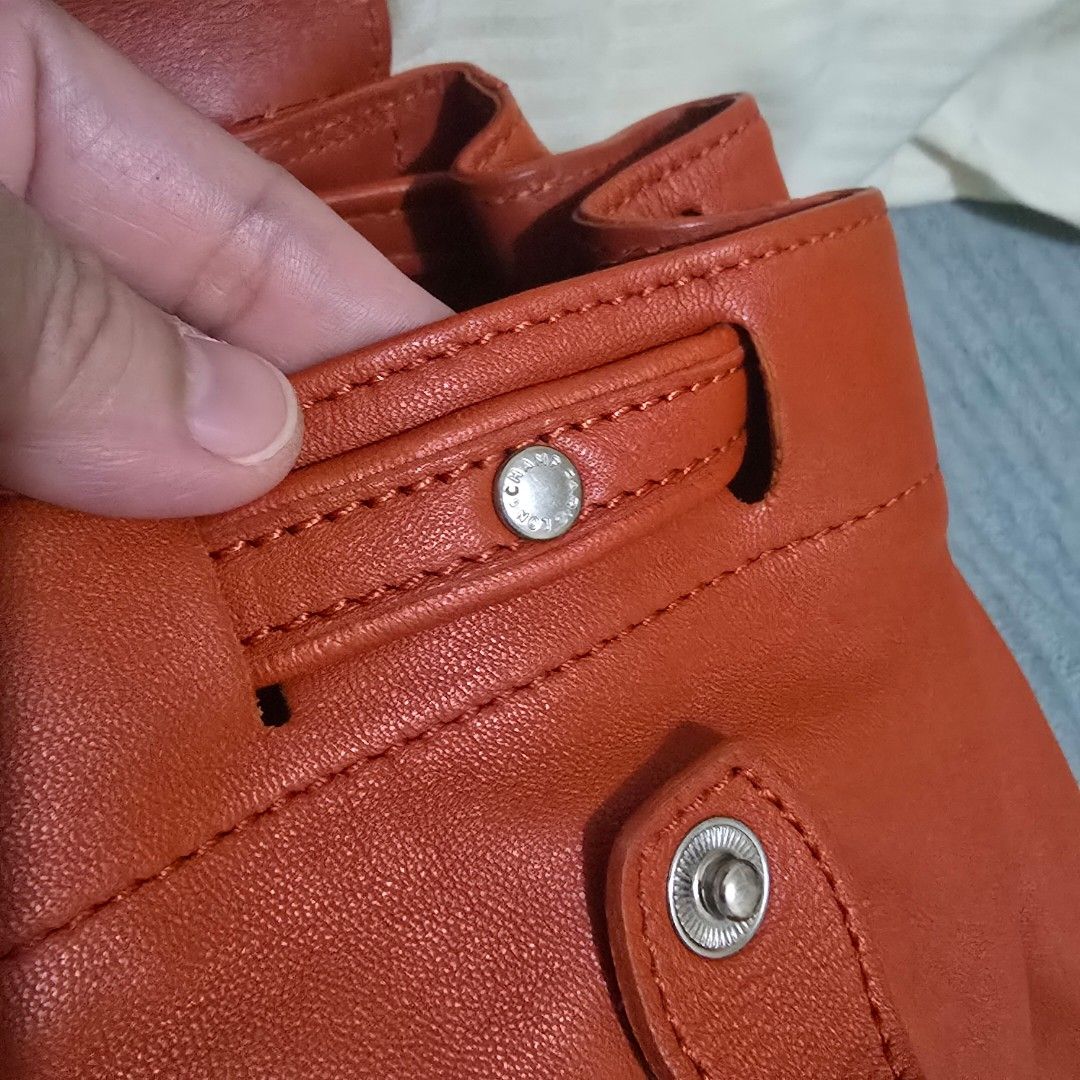 Longchamp Le Pliage Cuir Backpack Orange Leather (Category: Backpacks) located in Pasig City. Submitted by litinpink (Listing ID 1462053676, Image 3). Description: - Authentic Orange Longchamp Leather Backpack - Signature embossed horse and rider logo on flap - Secure drawstring closure with snap button flap - Interior zippered pocket for essentials - Playful horse print lining - Adjustable straps for comfortable wear.