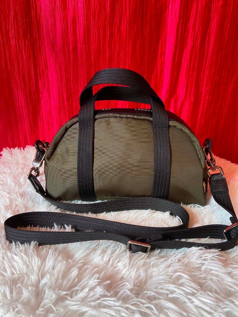 Longchamp Le Pliage Energy Bowling Bag (Category: Cross-body Bags) located in Bulacan. Submitted by bella.ken.varietystore (Listing ID 1462176714, Image 2). Description: Design details • Colour: Khaki • Canvas material made with recycled fibres • Leather trims • Silver‑tone hardware • Zip closure • Adjustable and removable strap • Two flat interior pockets.