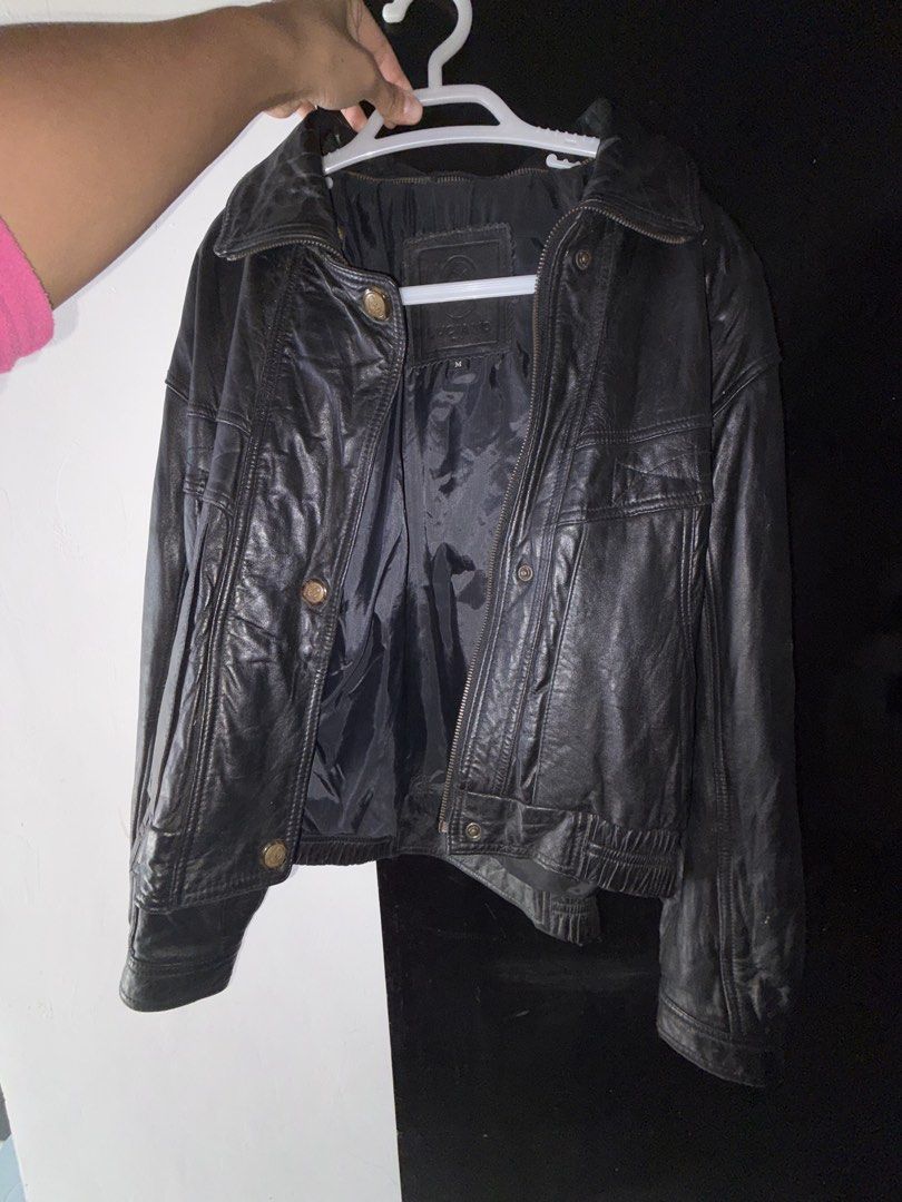 Luciano Black Leather Jacket (Category: Coats, Jackets and Outerwear) located in Baguio. Submitted by declutterain (Listing ID 1462063112, Image 3). Description: - Classic black leather jacket from Luciano - Size: Medium (M) - Features zip-up front with button closures - Two front pockets with button details - Snap closure on the collar - Versatile for layering or standalone wear - A timeless wardrobe essential.