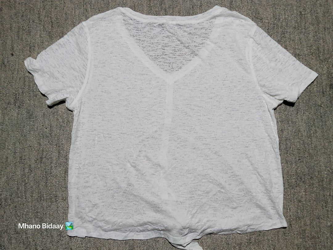 Lululemon Relaxed Tie Crop Top White Quick Drying (Category: Activewear) located in Valencia. Submitted by mhano_bidaay_outdoors_218 (Listing ID 1462190388, Image 3). Description: - White Lululemon tie crop top - V-neck style with short sleeves - Made with quick-drying fabric - Measurements: Chest width 17 inches, Length 18.5 inches - Ideal for workouts or casual wear.