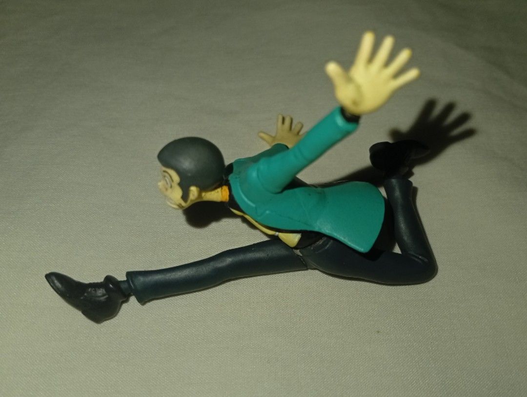 Lupin the Third / Daisuke Jigen figurine (Category: Figurines & Statues) located in Tarlac. Submitted by kio-kun (Listing ID 1462211546, Image 2). Description: 1.Lupin the Third (Arsène Lupin III) Banpresto *Signature green/teal jacket over a yellow shirt and dark trousers *Action-oriented mid-air jump, typically requiring a clear display stand or support base 2.Daisuke Jigen DyDo DRINKS (A well-known Japanese beverage company). *Cool, hard-boile