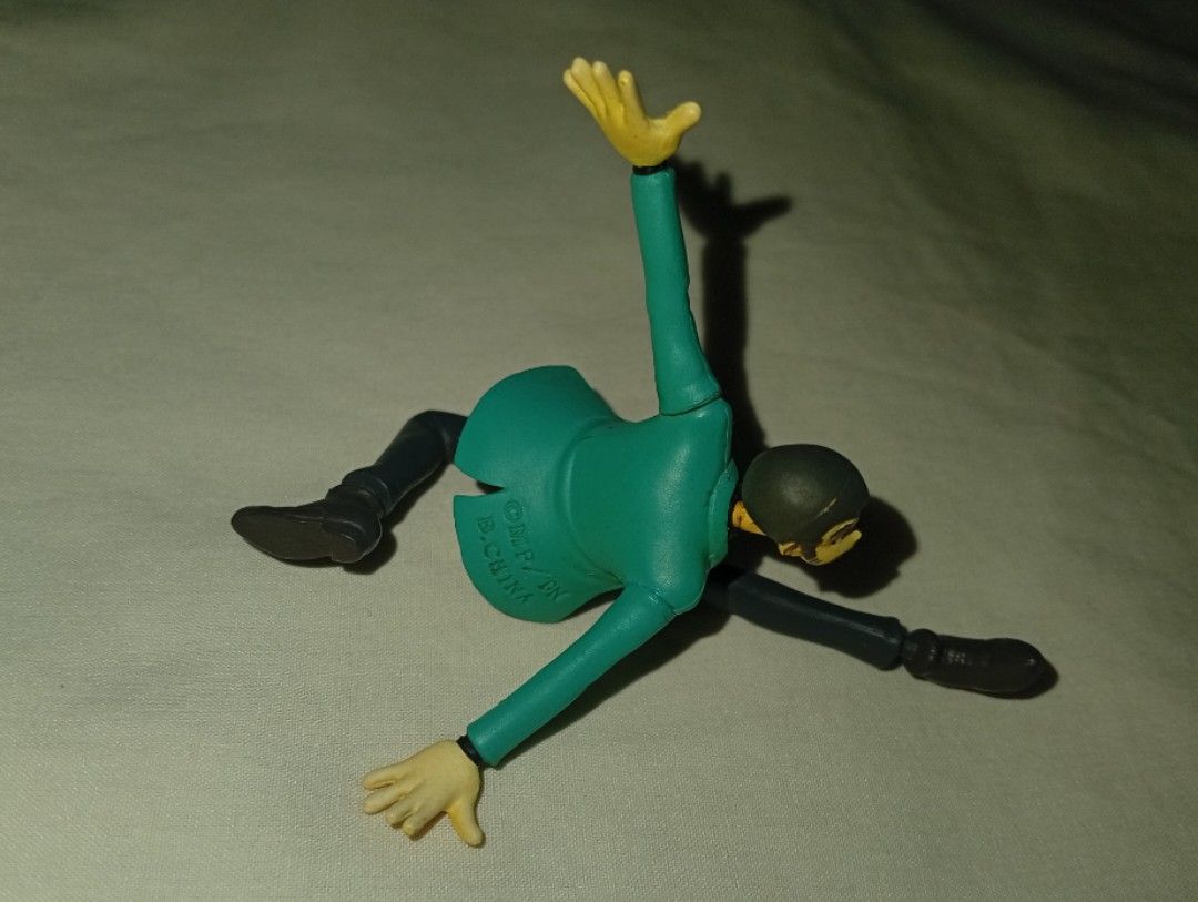Lupin the Third / Daisuke Jigen figurine (Category: Figurines & Statues) located in Tarlac. Submitted by kio-kun (Listing ID 1462211546, Image 3). Description: 1.Lupin the Third (Arsène Lupin III) Banpresto *Signature green/teal jacket over a yellow shirt and dark trousers *Action-oriented mid-air jump, typically requiring a clear display stand or support base 2.Daisuke Jigen DyDo DRINKS (A well-known Japanese beverage company). *Cool, hard-boile