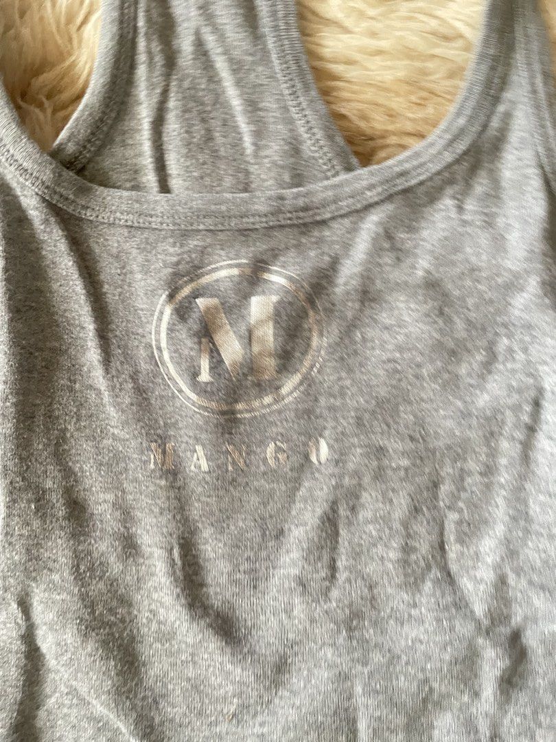 Mango Basics Grey Racerback Tank Top Size XS (Category: Sleeveless) located in Manila. Submitted by prelovedsbypink (Listing ID 1462151463, Image 2). Description: -can fit to Medium - Grey Mango Basics tank top - Racerback style - Features printed Mango logo on the front - Made in Vietnam - Ideal for layering or wearing solo - Comfortable and casual design.