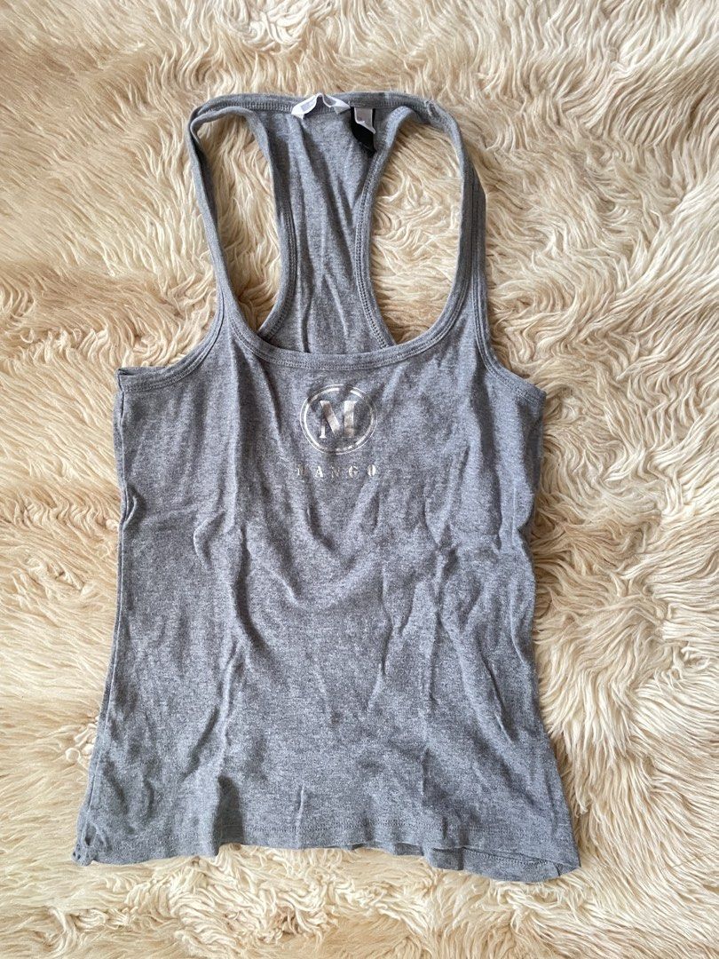 Mango Basics Grey Racerback Tank Top Size XS (Category: Sleeveless) located in Manila. Submitted by prelovedsbypink (Listing ID 1462151463, Image 1). Description: -can fit to Medium - Grey Mango Basics tank top - Racerback style - Features printed Mango logo on the front - Made in Vietnam - Ideal for layering or wearing solo - Comfortable and casual design.