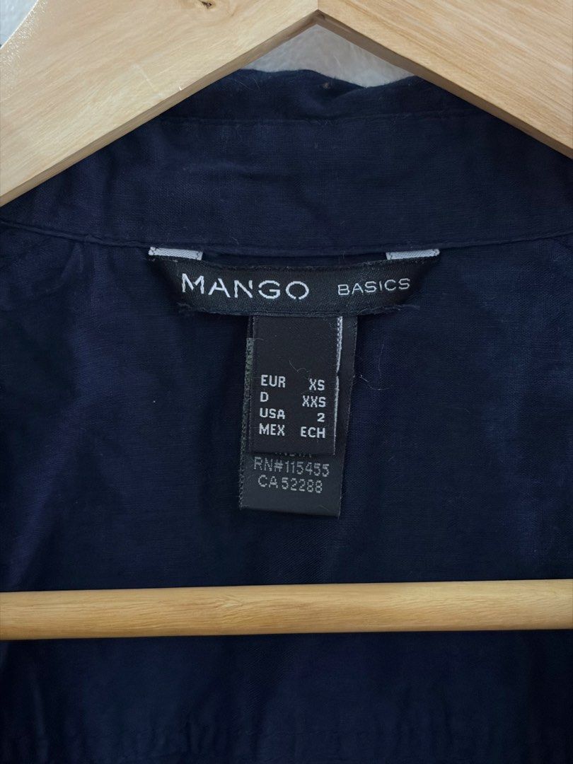 Mango Basics Navy Blue Button-Up Shirt 3/4 Sleeves (Category: Longsleeves) located in San Juan City. Submitted by sel.ler (Listing ID 1462126998, Image 2). Description: - Brand: Mango Basics - Color: Navy Blue - Sleeve Length: Three-quarter sleeves with button tabs for roll-up option - Pockets: Two chest pockets - Closure: Button-up front - Fabric: Lightweight, ideal for casual wear.
