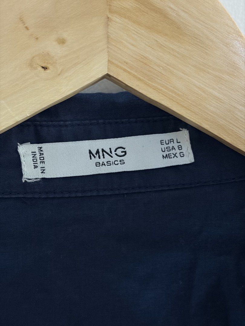 Mango Basics Navy Blue Long Sleeve Shirt (Category: Longsleeves) located in San Juan City. Submitted by sel.ler (Listing ID 1462126832, Image 2). Description: - Navy blue long sleeve shirt from MNG Basics - Button-up front with two chest pockets - Collared neckline - Made in India - Versatile for casual or work attire.