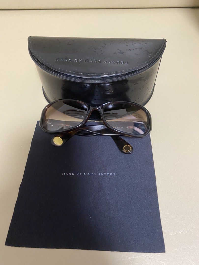 Marc by Marc Jacobs Sunglasses with Case (Category: Sunglasses & Eyewear) located in Agdangan. Submitted by aikara683 (Listing ID 1462054729, Image 1). Description: - Brand: Marc by Marc Jacobs - Style: Sunglasses - Frame Color: Tortoiseshell pattern - Accent Details: Gold accents on arms and front - Included Accessories: Original hard case and cleaning cloth - Perfect for: Sunny days.