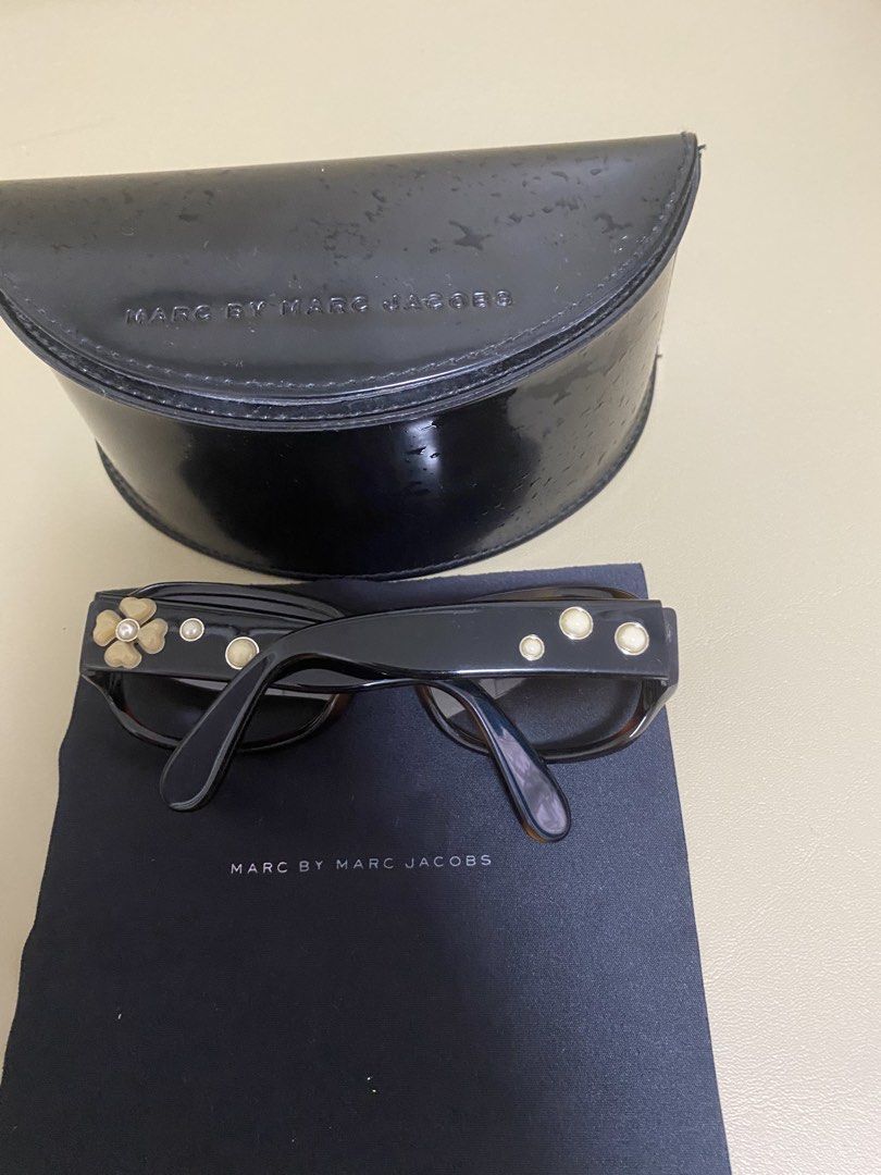 Marc by Marc Jacobs Sunglasses with Case (Category: Sunglasses & Eyewear) located in Agdangan. Submitted by aikara683 (Listing ID 1462054729, Image 3). Description: - Brand: Marc by Marc Jacobs - Style: Sunglasses - Frame Color: Tortoiseshell pattern - Accent Details: Gold accents on arms and front - Included Accessories: Original hard case and cleaning cloth - Perfect for: Sunny days.