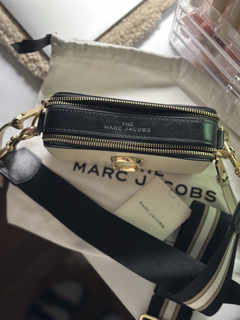 Marc Jacobs Snapshot Camera Bag Cream Gold (Category: Luxury Bags & Wallets) located in Manila. Submitted by tinne15 (Listing ID 1462157868, Image 3). Description: - Authentic Marc Jacobs Snapshot camera bag - Color: Cream and Black - Hardware: Gold - Includes original dust bag - Includes authenticity card - Strap features 'The Snapshot Marc Jacobs' print - Versatile for everyday use or evening events.
