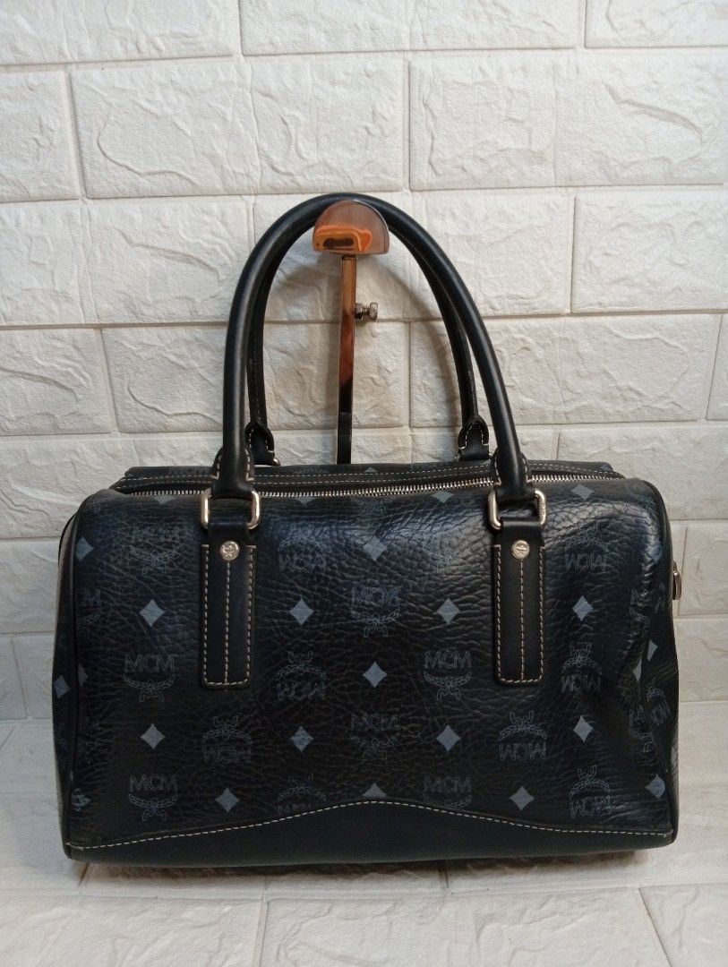 MCM Monogram Boston Bag Black Leather (Category: Shoulder Bags) located in Las Pinas. Submitted by etoksi1234 (Listing ID 1462181153, Image 2). Description: Pre-loved MCM Black Visetos Boston Bag featuring the brand's signature monogram coated canvas and a hanging metallic logo charm. Silver tone hardware..