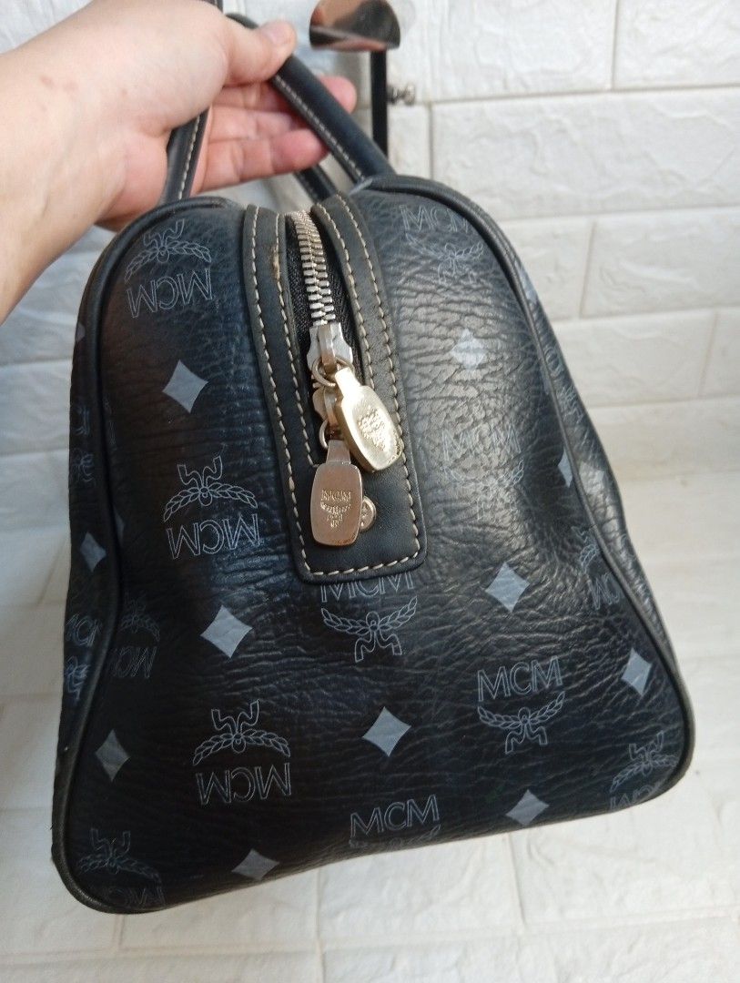 MCM Monogram Boston Bag Black Leather (Category: Shoulder Bags) located in Las Pinas. Submitted by etoksi1234 (Listing ID 1462181153, Image 3). Description: Pre-loved MCM Black Visetos Boston Bag featuring the brand's signature monogram coated canvas and a hanging metallic logo charm. Silver tone hardware..
